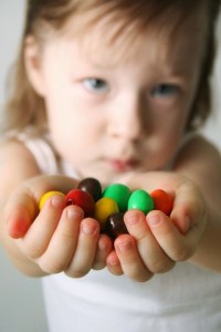 girl giving candy